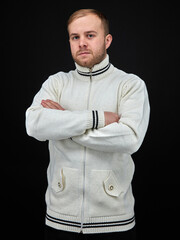 vertical portrait  blond man on a dark background, in a jacket