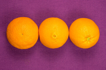 oranges on a purple background