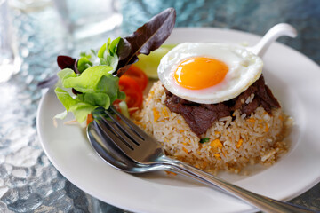 Beef Fried Rice with Fried Egg put on a glass table concept fast food.