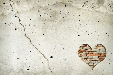 Heart shape made of old bricks on concrete wall. Valentines day background with heart shape and...