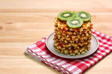 sweet waffles and kiwi slices on the table.