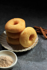 Stack of delicious donuts on wooden table