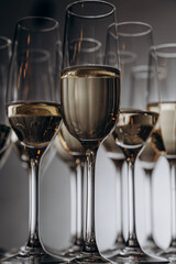 sparkling wine is poured into beautiful glasses standing on a wooden table