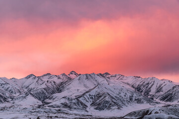 amazing sky at sunrise over the snowy mountains