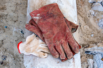 construction gloves on concrete floor