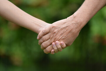 granddaughter and grandmother holding hands