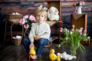 Fototapeta premium Cute toddler blond child, boy with easter decoration