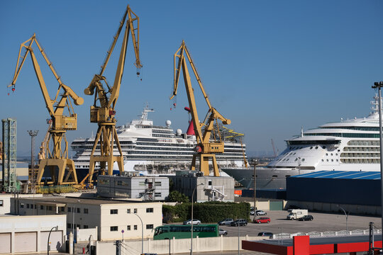 Modern cruise ship liner or cruiseship in dry dock maintenance refurb modernization overhaul repair in Spanish shipyard in Cadiz, Spain with dock and cranes	