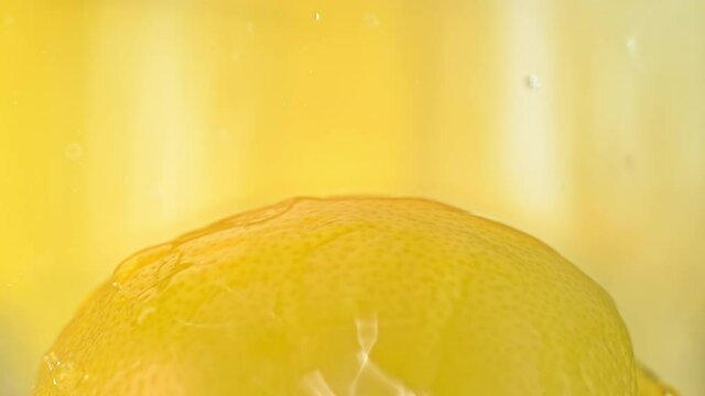 Lemon  Fruit Splashed by Water in Slow Motion on the Yellow Background