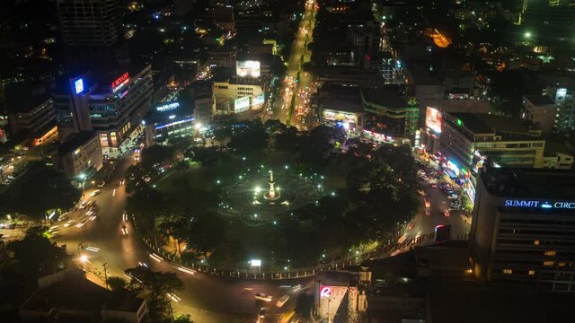 Zoom out timelapse view of night traffic at Fuente Osmena Circle in the heart of Cebu City, Philippines.