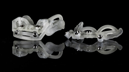 unusual dental surgical templates for implantation on a black background