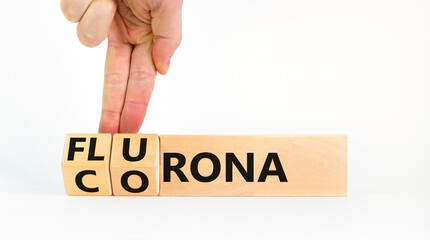 Covid-19 corona and flu flurona symbol. Doctor turns cubes and changes the word corona to flurona. Beautiful white background. Medical, covid-19 corona and flu flurona concept. Copy space.