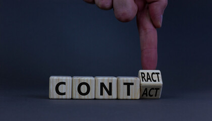 From contact to contract symbol. Businessman turns a wooden cube and changes the word contact to contract. Beautiful grey background, copy space. Business, from contact to contract concept.
