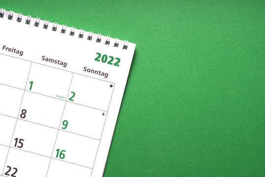 german calendar for the new year 2022 on green paper background