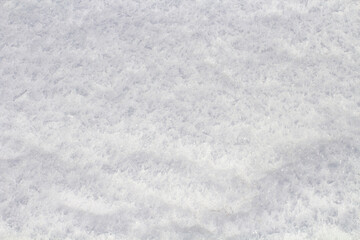 Texture of fresh snow closeup, abstract winter background, top view, copy space.