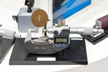 accuracy and precision digital micrometer equipment for measuring dimension industrial work during or inspection sprocket workpiece on table