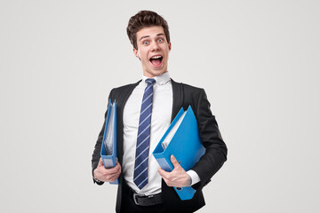 Happy accountant with folders in studio