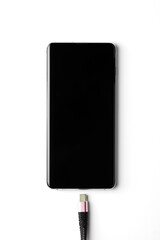 Smartphone and a charger on white background