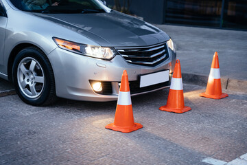 Cones for the examination, driving school. Driving lesson. Parking. Examination car.