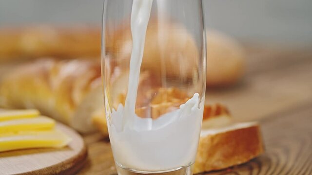 Preparing Rustical Breakfast by Pouring Milk into Glass in Super Slow Motion