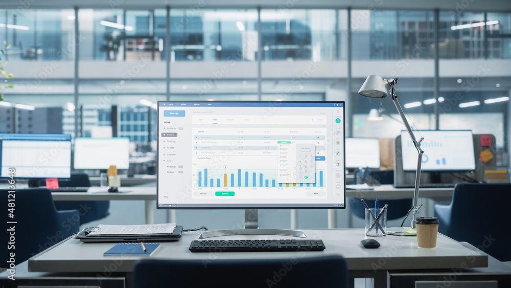 Poster Desktop Computer Monitor with Finance Statistical Data Software and Progressive User Interface Standing on the Desk in the Modern Business Office. In the Background Glass Wall with Big City Office.