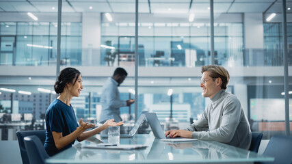 Multiethnic Diverse Office Conference Room Meeting: Team of Two Creative Entrepreneurs Talk, Discuss Growth Strategy. Stylish Young Businesspeople work on Digital e-Commerce Startup Project.