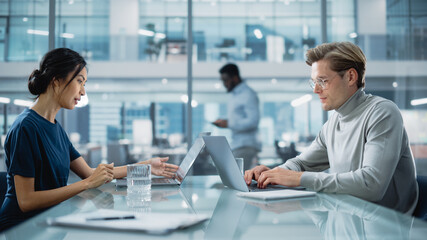 Multiethnic Diverse Office Conference Room Meeting: Team of Two Creative Entrepreneurs Talk, Discuss Growth Strategy. Stylish Young Businesspeople work on Investment and Marketing Projects.