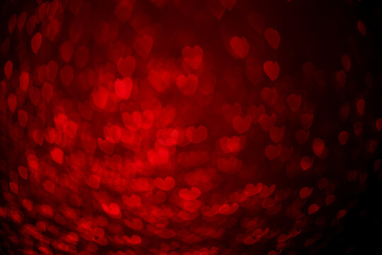 Red hearts, sparkling glitter bokeh background, valentines day abstract defocused texture