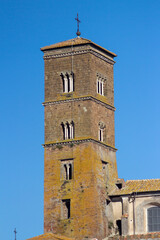 Fototapeta na wymiar Bell tower of The Santa Maria Assunta Cathedral(Sutri)is one of the few remains of the medieval church, from the single lancet window on the lowest floor to the four lancet window on the highest floor