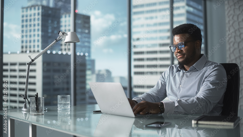 Aufkleber confident businessman in striped shirt sitting at a desk in modern office, using laptop computer nex
