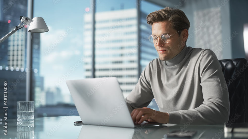 Poster creative businessman in a turtleneck jumper sitting in modern office, using laptop computer next to 