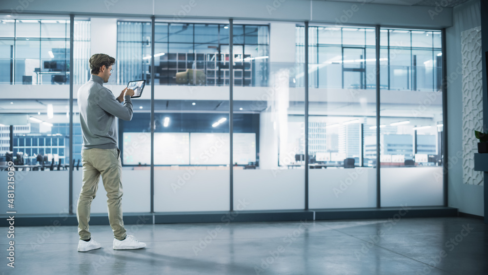 Poster handsome stylish interior designer standing in empty modern office and map it with an augmented real
