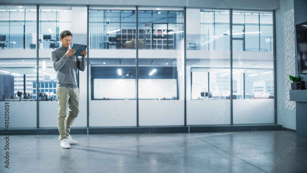 Poster handsome stylish interior designer standing in empty modern office and map it with an augmented real