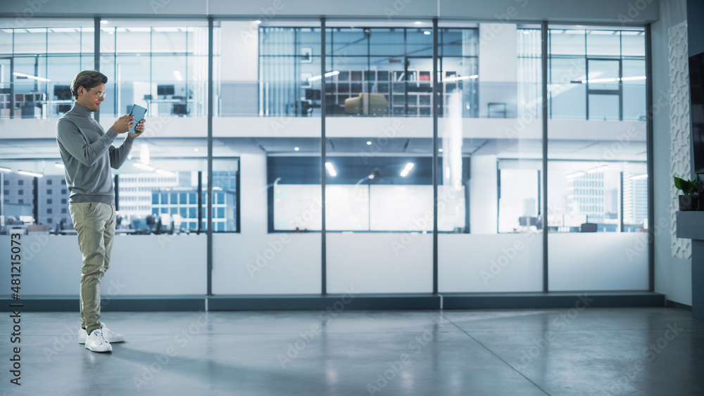 Poster handsome stylish interior designer standing in empty modern office and map it with an augmented real