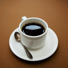 Coffee cup isolated on brown table. Coffee drink with copy space. Square image.