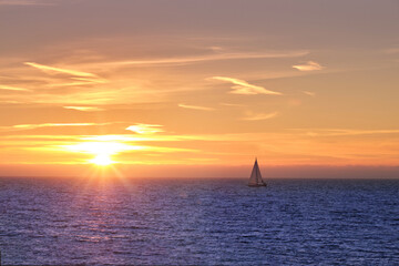 sunset on the sea with boat on the horizon