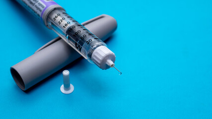 Insulin pen. Insulin pen fill with needle on white background. Diabetes Day.