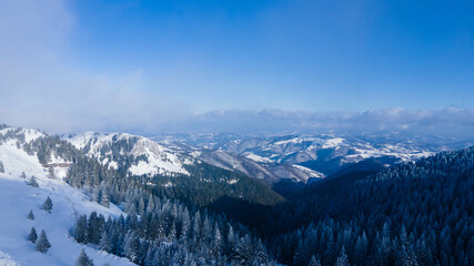 Beautiful aerial landscape view of snow covered mountain with a colorful sky.