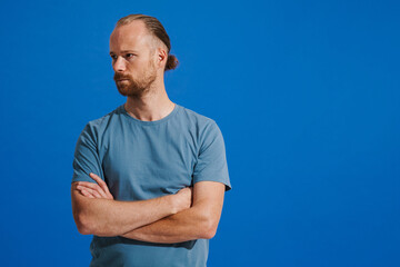 Ginger white man with beard posing with arms crossed