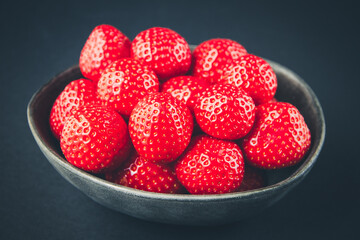 Strawberries in a bowl. Black background
