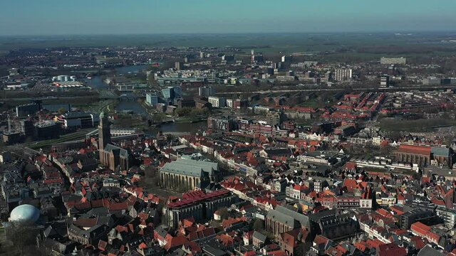 Aerial top view of a city in Holland, surrounded by houses, green trees and canal