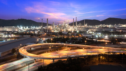 Oil and gas refinery plant and storage tank form industry zone on Island at twilight and U-turn...