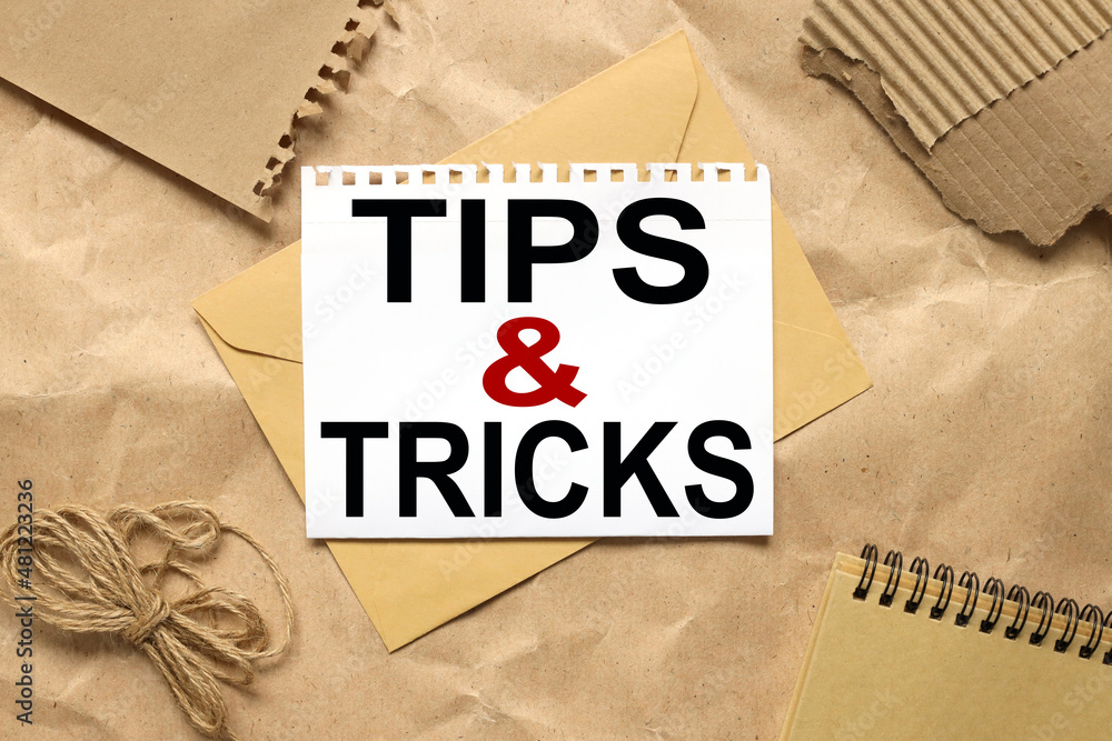 Poster tips and tricks symbol. text on white paper on envelope. tips and tricks concept. copy space.