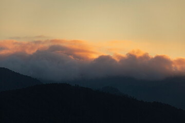 Sunset landscape formed by the hills, the clouds and the last lights, in front of the Garita da Vela, from Espasante, council of Ortigueira, Galicia, Spain