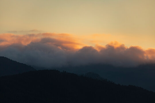 Sunset landscape formed by the hills, the clouds and the last lights, in front of the Garita da Vela, from Espasante, council of Ortigueira, Galicia, Spain