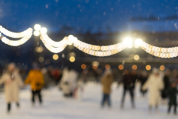 Unrecognizable people ice skate on the rink. Blur people in skates.