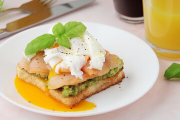 Breakfast with a sandwich with poached egg and avocado	
