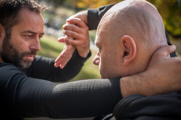 Street fighting self defense technique against holds and grabs