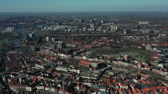 Aerial top view of a city in Holland, surrounded by houses, green trees and canal
