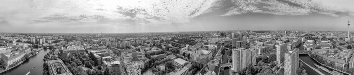 Panoramic aerial view of Berlin skyline at sunset with major city landmarks along Spree river,...